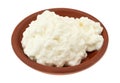 Cottage cheese in a small red clay bowl