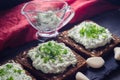 Cottage cheese smeared with bread. Sprinkled with green onions and dill