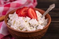 Cottage cheese with strawberries in a clay bowl. Close-up. Royalty Free Stock Photo