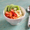 Cottage cheese with strawberries, kiwi, honey and flax seeds - healthy Breakfast in a white bowl Royalty Free Stock Photo