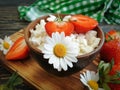 Cottage cheese, strawberry calcium , chamomile flower on a wooden background