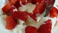 Cottage cheese in a strawberry spoon slow motion