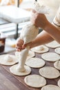 Cottage cheese stuffing baked rolled buns at bakery house baking sheet pan wooden table with flour bread white flour