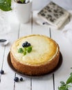 Cottage cheese tart with poppy seeds and blueberries on a light table. Bright spring photo with flowers. Royalty Free Stock Photo