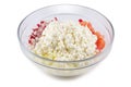 Cottage cheese, tomatoes, cucumbers and radishes, cut into cubes in a glass bowl, on a white background