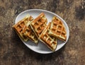 Cottage cheese waffles - delicious sweet dessert on a wooden background, top view