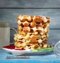 Cottage cheese waffles stacked in a slide on a multi-colored ceramic plate