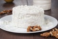 Cottage cheese in white plate on wooden table Royalty Free Stock Photo