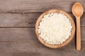 Cottage cheese in a wooden bowl on old wooden background with copy space for your text. Top view Royalty Free Stock Photo
