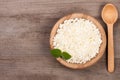 Cottage cheese in a wooden bowl on old wooden background with copy space for your text. Top view Royalty Free Stock Photo