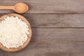 Cottage cheese in a wooden bowl on old wooden background with copy space for your text. Top view Royalty Free Stock Photo