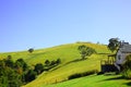 Cottage countryside landscape with blue sky and mountains Royalty Free Stock Photo