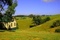 Cottage countryside landscape with blue sky and mountains Royalty Free Stock Photo