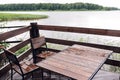 Cottage in forest near river with big wooden terrace. House on the water at the lake, a beautiful bank. Ideal place for Royalty Free Stock Photo