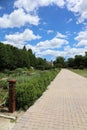 Cottage gardens lining brick walkways leading to a stone cottage in Boerner Botanical Gardens