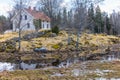 Cottage on a hill in the countryside by a flooded meadow at spring Royalty Free Stock Photo
