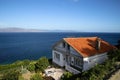 Cottage on the hillside by the sea