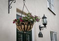 Front view of a luxury, detached cottage showing its hanging basket and security lantern