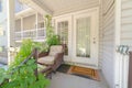 Cottage pane front door wicker armchairs and stairs viewed at the home entrance Royalty Free Stock Photo