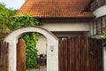 Cottage red roof house with garden wooden wicket.  Opened wooden gate. Royalty Free Stock Photo