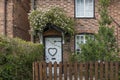 Cottage with roses growing above the door Royalty Free Stock Photo