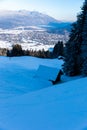 Cottage in snow covered mountain side with view over Garmisch Partenkirchen Royalty Free Stock Photo