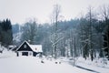 Cottage in snowy mountains country, foggy winter day, Czech republic