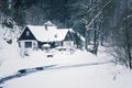 Cottage in snowy mountains country, foggy winter day, Czech republic