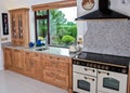 Cottage style kitchen in wooden finish and granite worktop Royalty Free Stock Photo