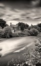 English cottage by a weir Long exposure.