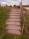 A close up shot of stairs leading down to a beach Royalty Free Stock Photo