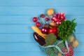 Cotton bag full of fresh farm raw vegetables from local farmer market, on blue wooden background or table. Healthy organic food Royalty Free Stock Photo