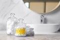 Cotton balls, swabs and pads on grey marble table in bathroom Royalty Free Stock Photo