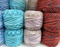 cotton balls of yarn, multi-colored spools of thread. Hobby, crochet and knitting, blue yarn, red and blue threads Royalty Free Stock Photo