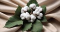 Cotton branch with green leaves on knitted background. Royalty Free Stock Photo