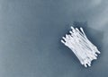 Cotton buds in a container on a gray background. narrow light.