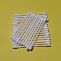 Cotton buds isolated on the yellow background.