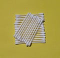 Cotton buds isolated on the yellow background.