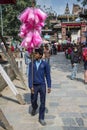 A cotton candy peddler walks in street in Dasain Festival , Kathmandu , Nepal