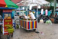 A cotton candy seller preparing as stock to sell to children in a city park