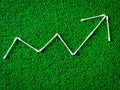 Cotton ear sticks arranged as a Increase and decrease graph on green background.