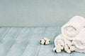 Cotton Flowers and Fresh Laundered Towels Against Blue Background