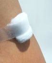 Cotton and gauze covering bloodstains on the arm of a person who has received injections or vaccines Royalty Free Stock Photo