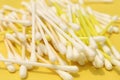 Cotton made ear buds all together close display on yellow background.