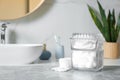 Cotton pads and balls on light grey table in bathroom Royalty Free Stock Photo