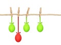 Cotton rope and four pins with hanging Easter painted eggs Royalty Free Stock Photo