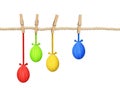 Cotton rope and four pins with hanging Easter painted eggs Royalty Free Stock Photo