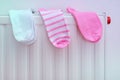 Cotton socks drying on a radiator of central heating, wet clothes hanging on a heater after washing and laundry, clean