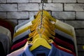 Cotton and sports t-shirts hung on wall hanger racks inside a clothes shop low angle view with the focused depth of field Royalty Free Stock Photo
