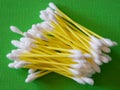 Cotton Swab Array. White-tipped swabs with yellow stems, green backdrop Royalty Free Stock Photo
